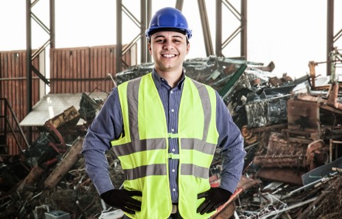 Safety trainer demonstrating manual handling during skip hire training